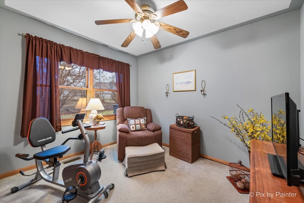 705 Cherry Tree Lane Genoa, IL 60135 - Photo 13 of 31 a livingroom with workspace and a window