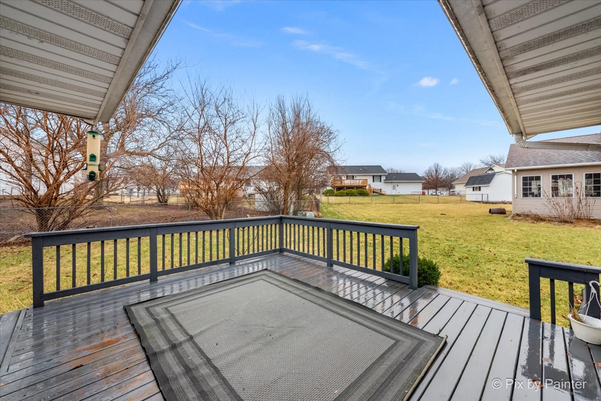 705 Cherry Tree Lane Genoa, IL 60135 - Photo 25 of 31 a view of a roof deck with wooden floor and fence
