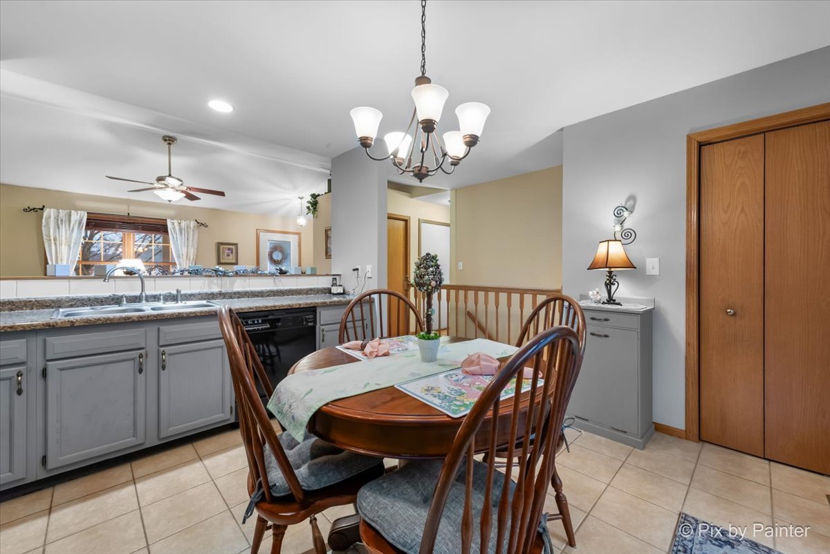 705 Cherry Tree Lane Genoa, IL 60135 - Photo 6 of 31 a view of a dining room with furniture and a chandelier