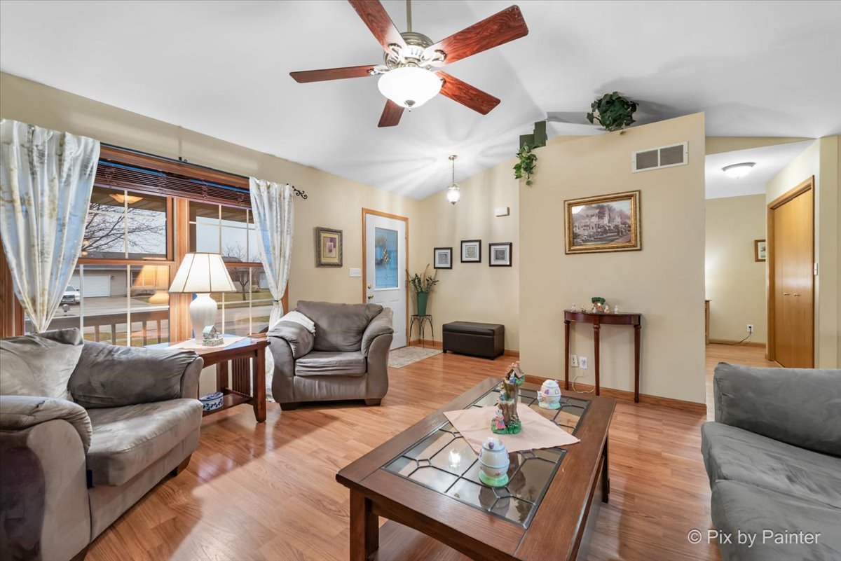 705 Cherry Tree Lane Genoa, IL 60135 - Photo 8 of 31 a living room with furniture and a large window