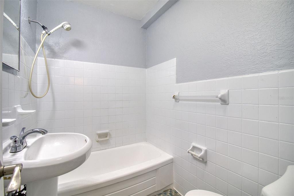 3315 58th Avenue South, Unit 112 St. Petersburg, FL 33712 - Photo 13 of 38 a bathroom with a sink a toilet and shower
