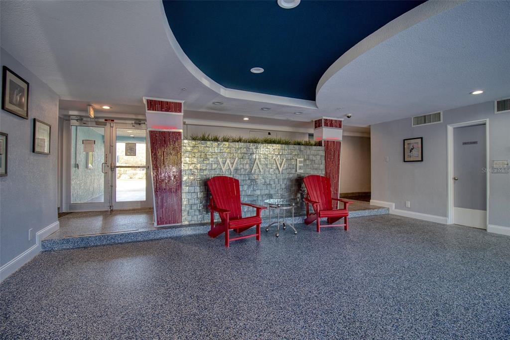 3315 58th Avenue South, Unit 112 St. Petersburg, FL 33712 - Photo 23 of 38 a living room filled with furniture and gym equipment