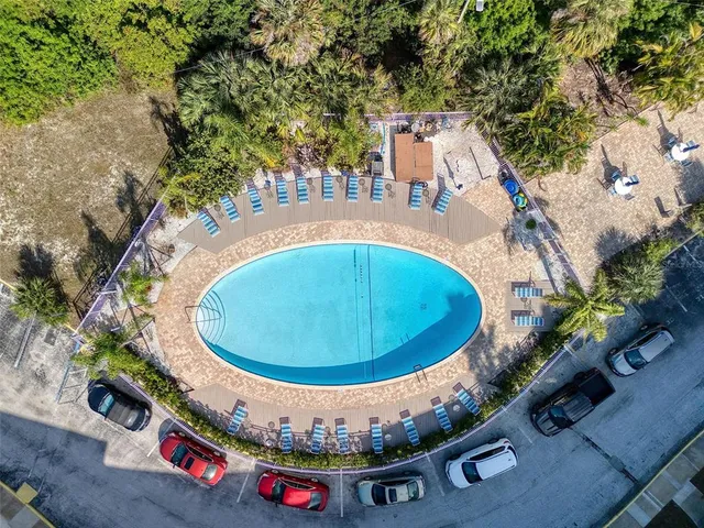 a swimming pool with outdoor seating and yard