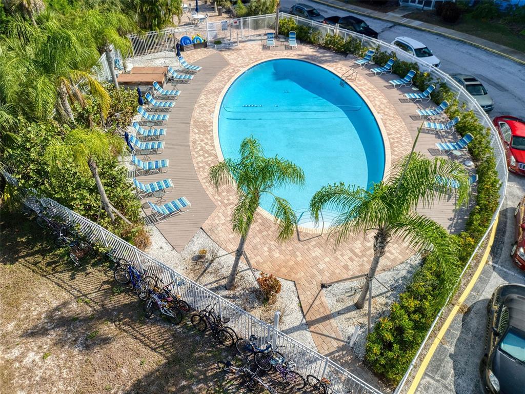 3315 58th Avenue South, Unit 112 St. Petersburg, FL 33712 - Photo 29 of 38 an aerial view of a swimming pool with outdoor seating