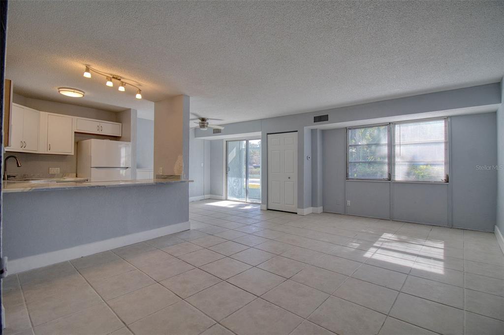 3315 58th Avenue South, Unit 112 St. Petersburg, FL 33712 - Photo 4 of 38 a view of an empty room with kitchen and window