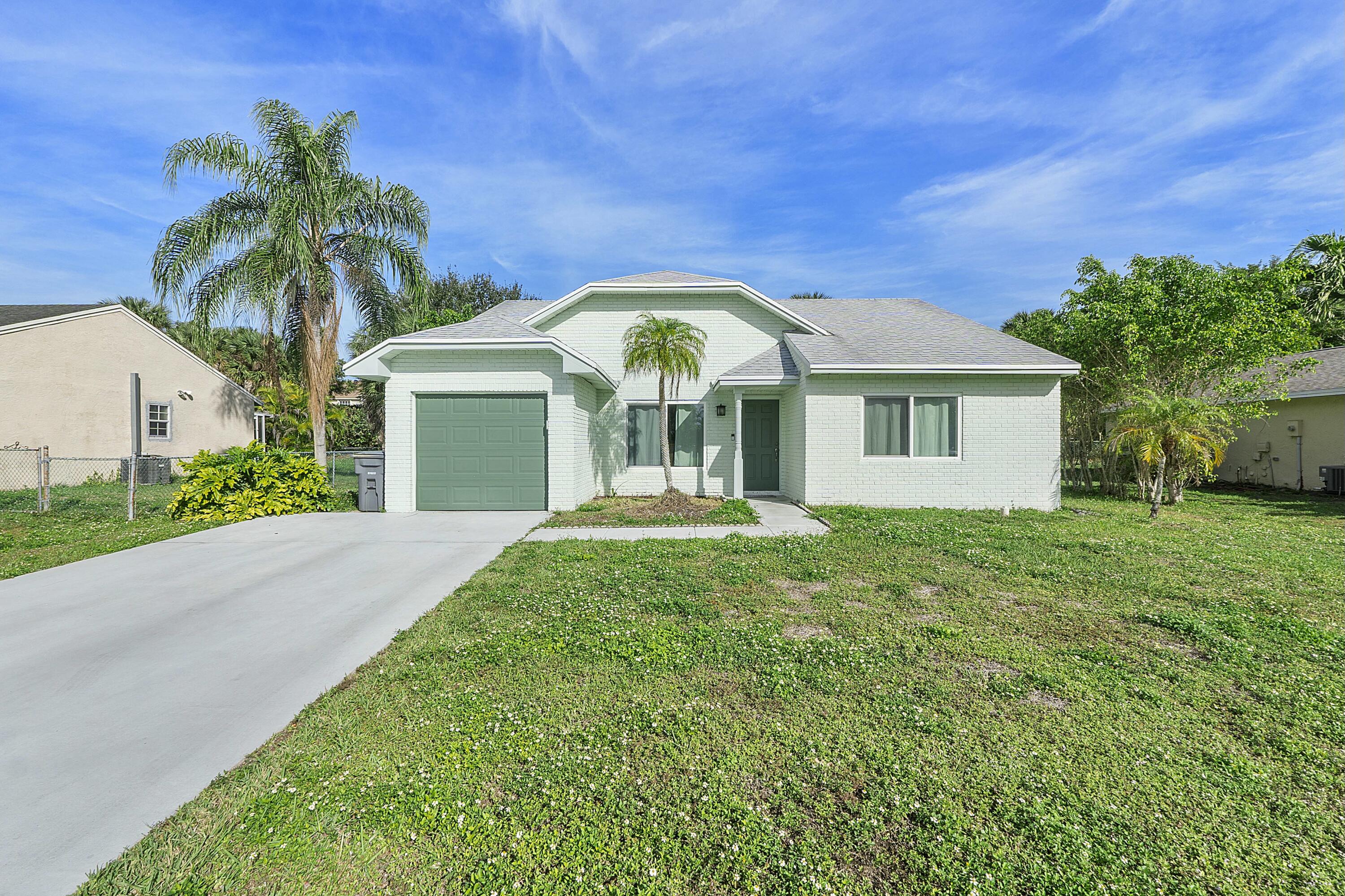 8143 Cedar Hollow Lane Boca Raton, FL 33433 - Photo 1 of 29 a view of a house with a yard and palm trees