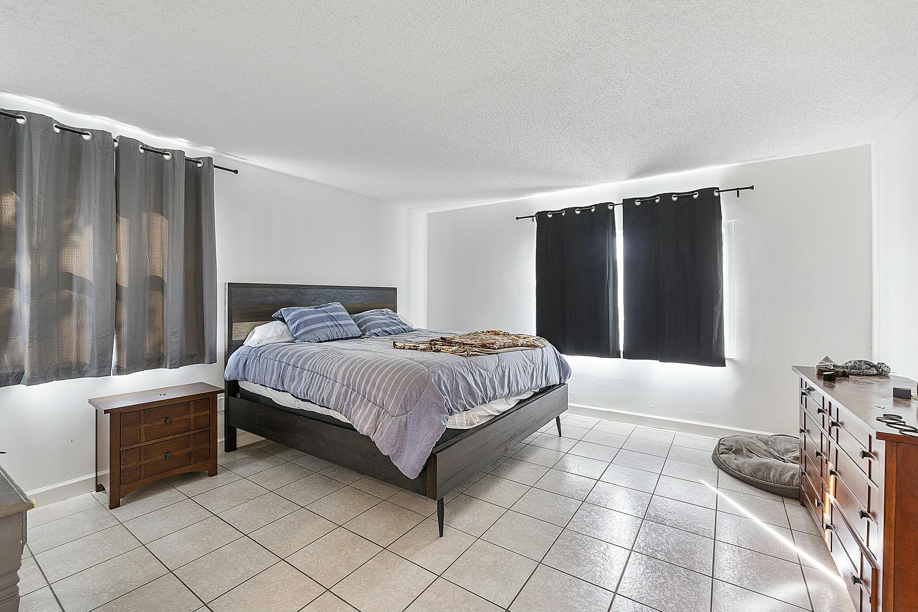 8143 Cedar Hollow Lane Boca Raton, FL 33433 - Photo 17 of 29 a bedroom with a bed and a window