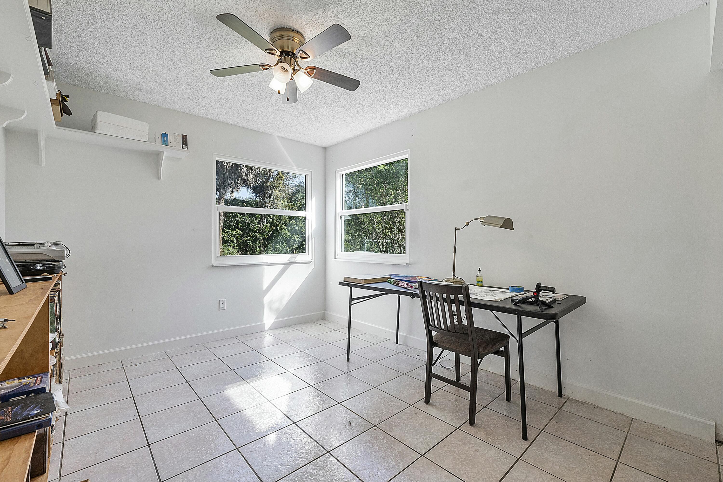 8143 Cedar Hollow Lane Boca Raton, FL 33433 - Photo 20 of 29 a view of a workspace with furniture and a window