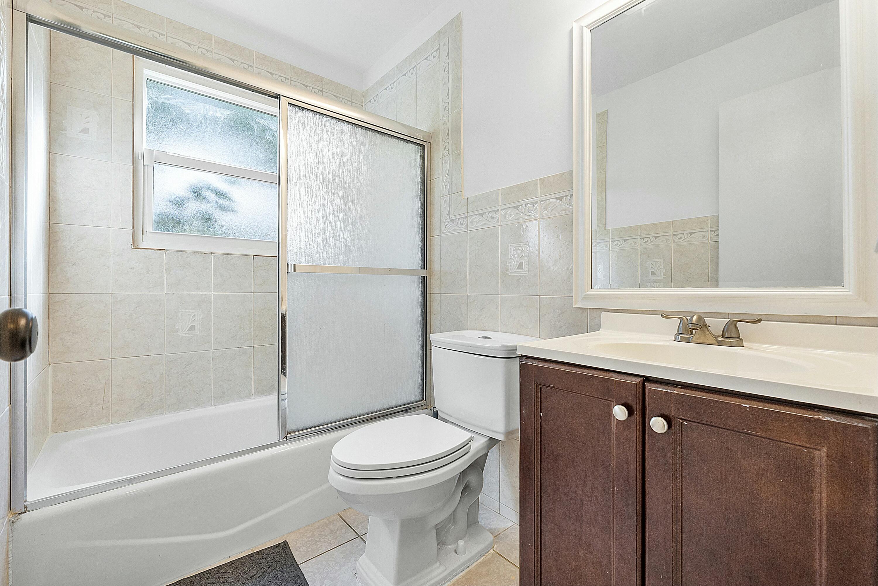 8143 Cedar Hollow Lane Boca Raton, FL 33433 - Photo 22 of 29 a bathroom with a sink a toilet and shower