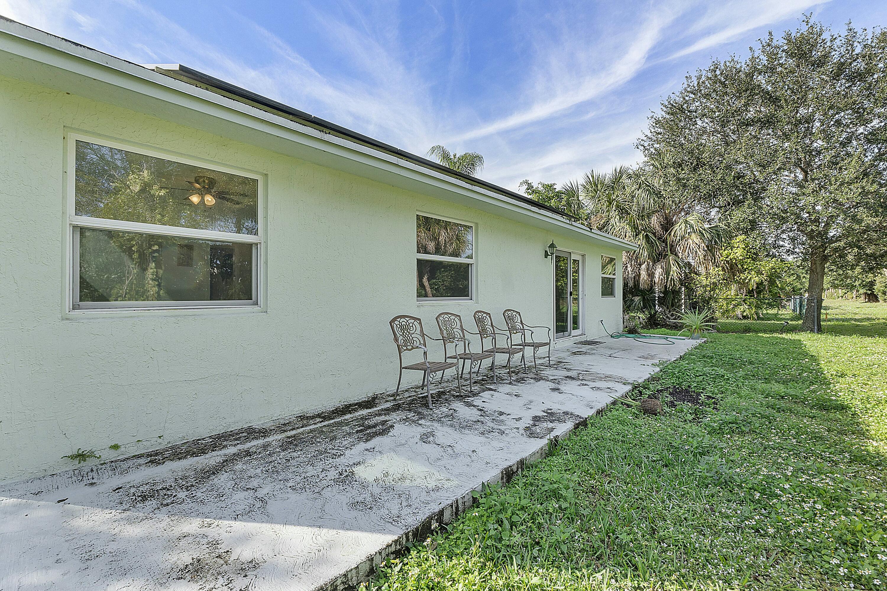 8143 Cedar Hollow Lane Boca Raton, FL 33433 - Photo 25 of 29 a front view of a house with garden