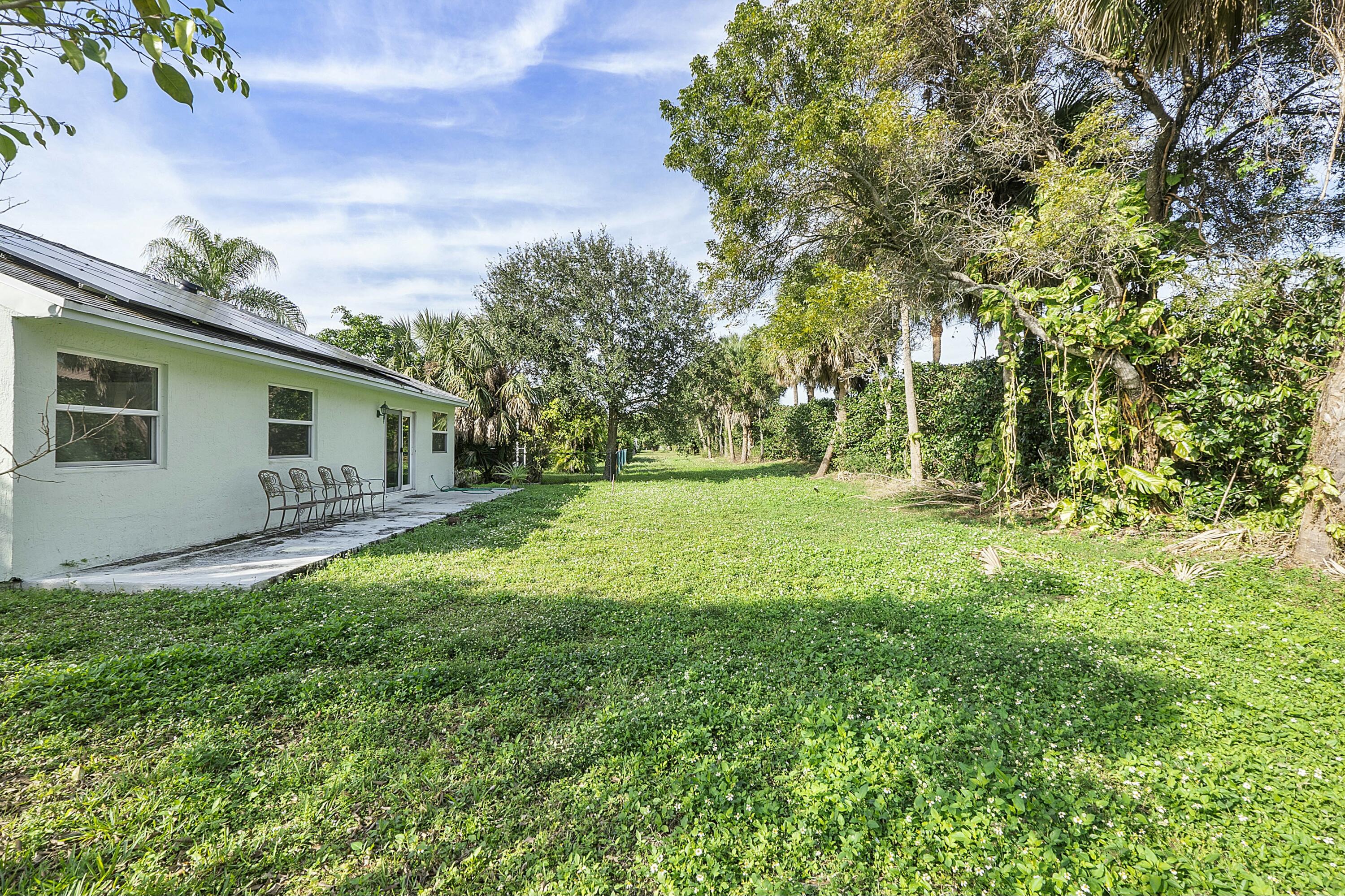 8143 Cedar Hollow Lane Boca Raton, FL 33433 - Photo 28 of 29 a backyard of a house with lots of green space