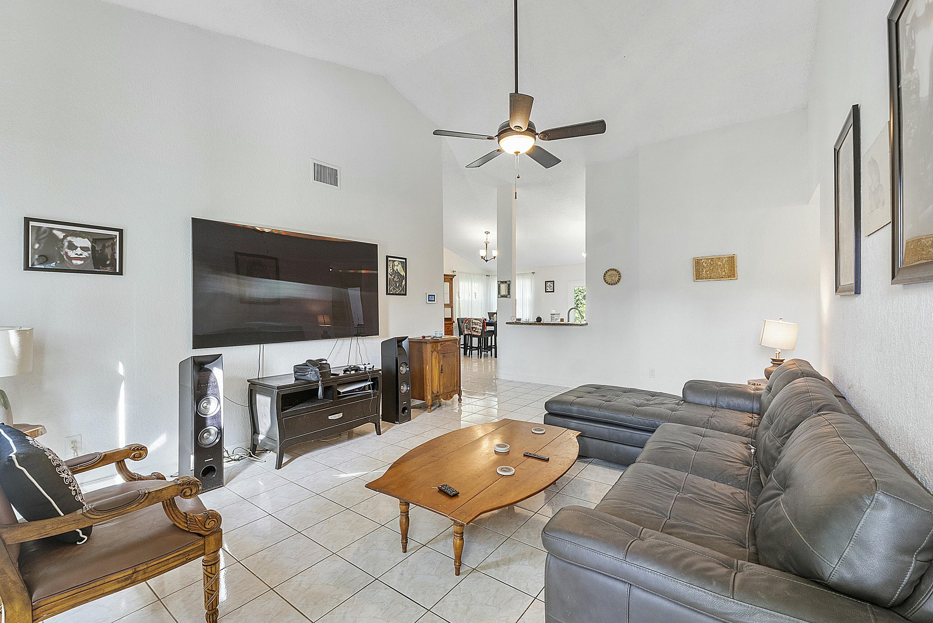 8143 Cedar Hollow Lane Boca Raton, FL 33433 - Photo 6 of 29 a living room with furniture and a flat screen tv