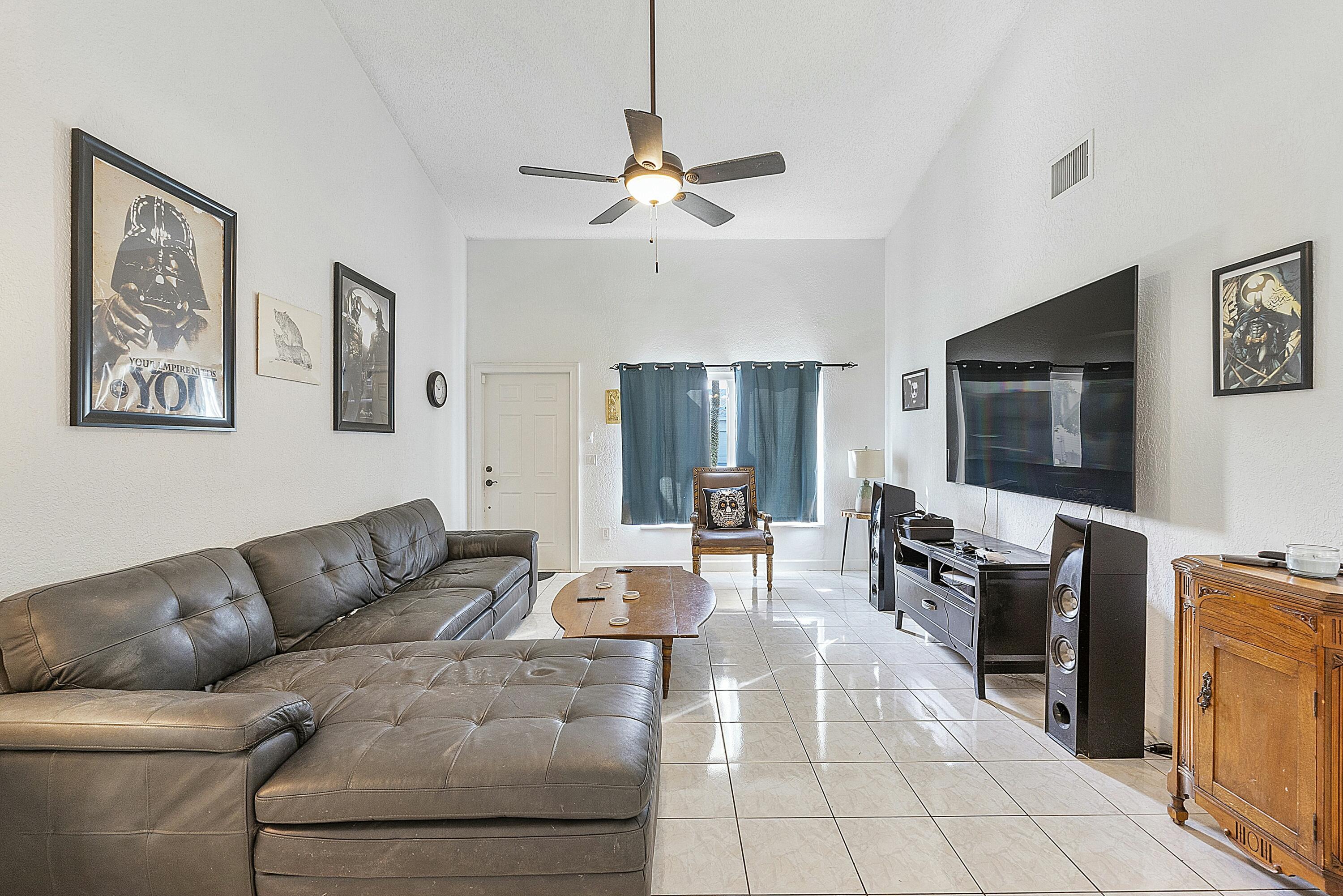 8143 Cedar Hollow Lane Boca Raton, FL 33433 - Photo 7 of 29 a living room with furniture and a flat screen tv