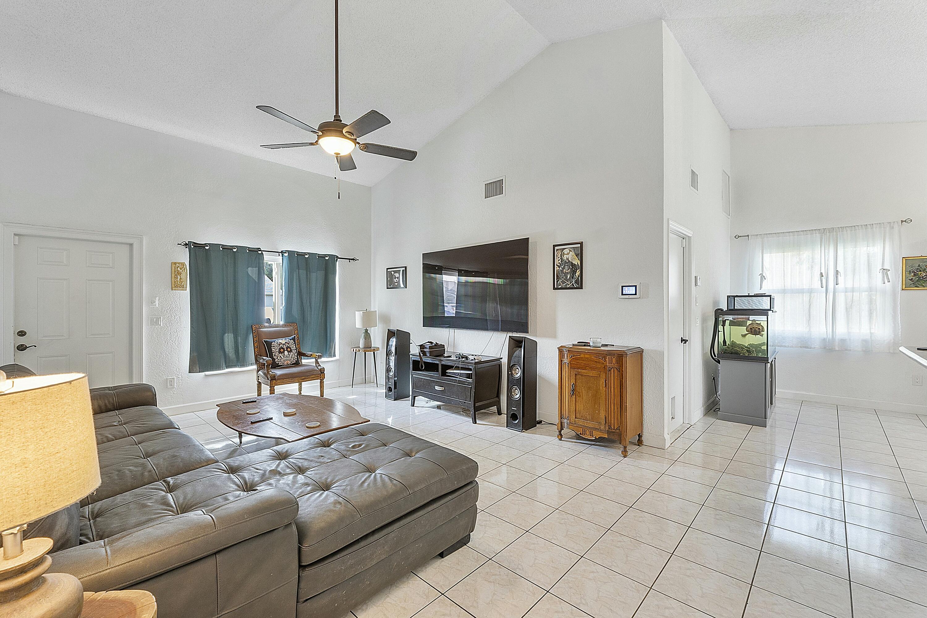 8143 Cedar Hollow Lane Boca Raton, FL 33433 - Photo 9 of 29 a living room with furniture and a flat screen tv