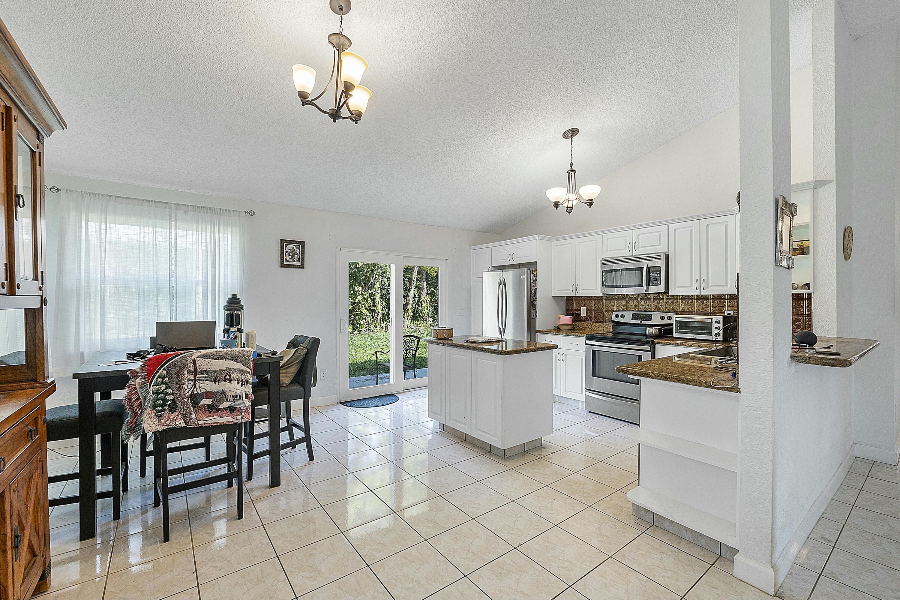 8143 Cedar Hollow Lane Boca Raton, FL 33433 - Photo 10 of 29 a dining room with furniture and window