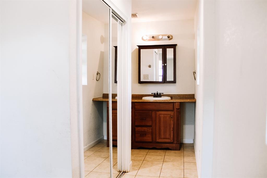 311 Spann Street Bangs, TX 76823 - Photo 11 of 17 a bathroom with a sink and a mirror