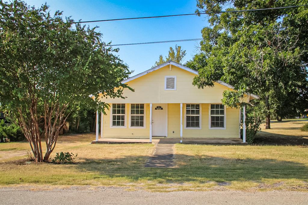 311 Spann Street Bangs, TX 76823 - Photo 2 of 17 a front view of a house with a yard
