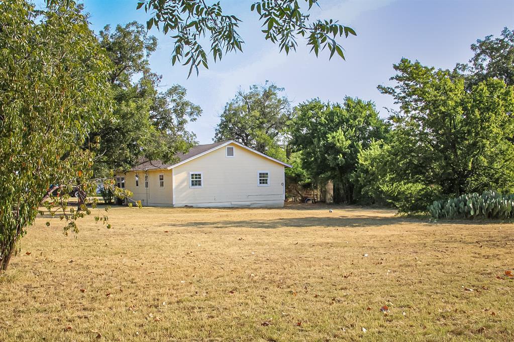 311 Spann Street Bangs, TX 76823 - Photo 4 of 17 a front view of a house with a yard