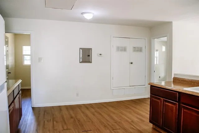 a view of bathroom with sink mirror and wooden floor