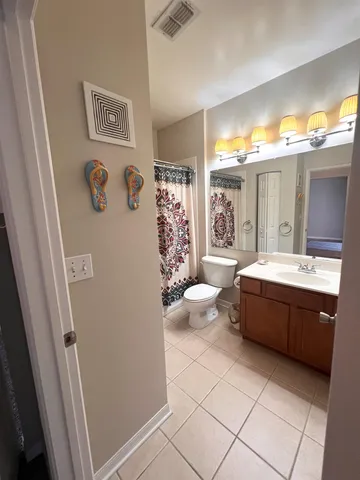 a spacious bathroom with a bathtub sink and toilet