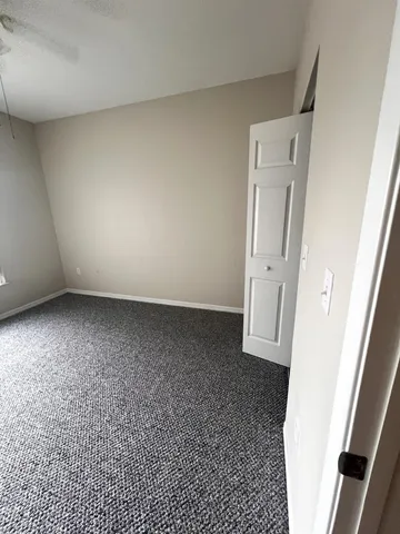 an empty room with a wooden door