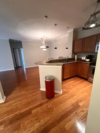 a kitchen with stainless steel appliances granite countertop a stove and a wooden floors
