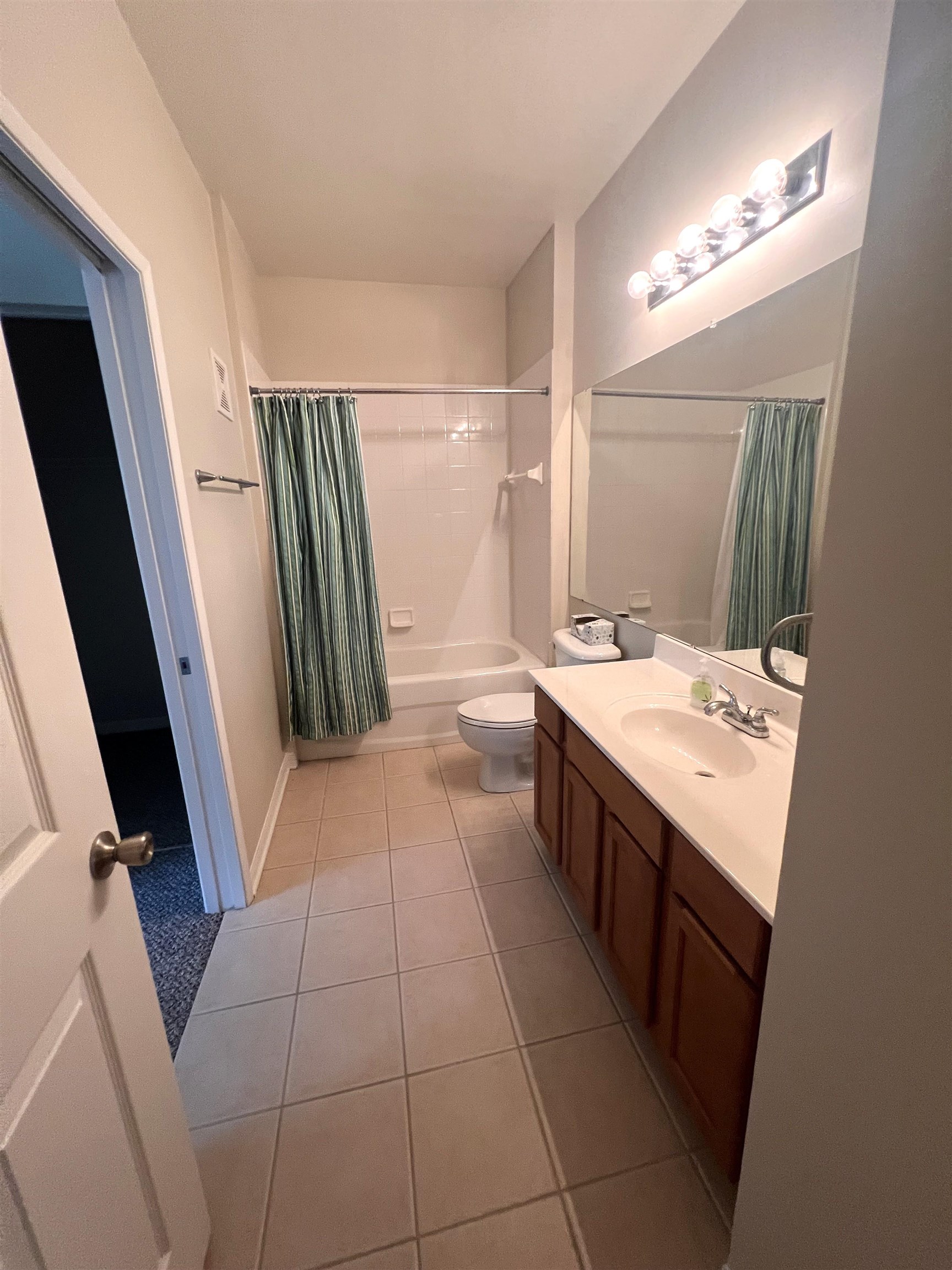 520 Florida Club Boulevard, Unit 212 St. Augustine, FL 32084 - Photo 21 of 28 a bathroom with a sink a toilet a mirror and vanity