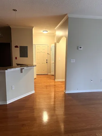 a view of a kitchen with wooden floor and a sink
