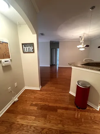 a view of a kitchen with kitchen island a sink wooden floor and glass door