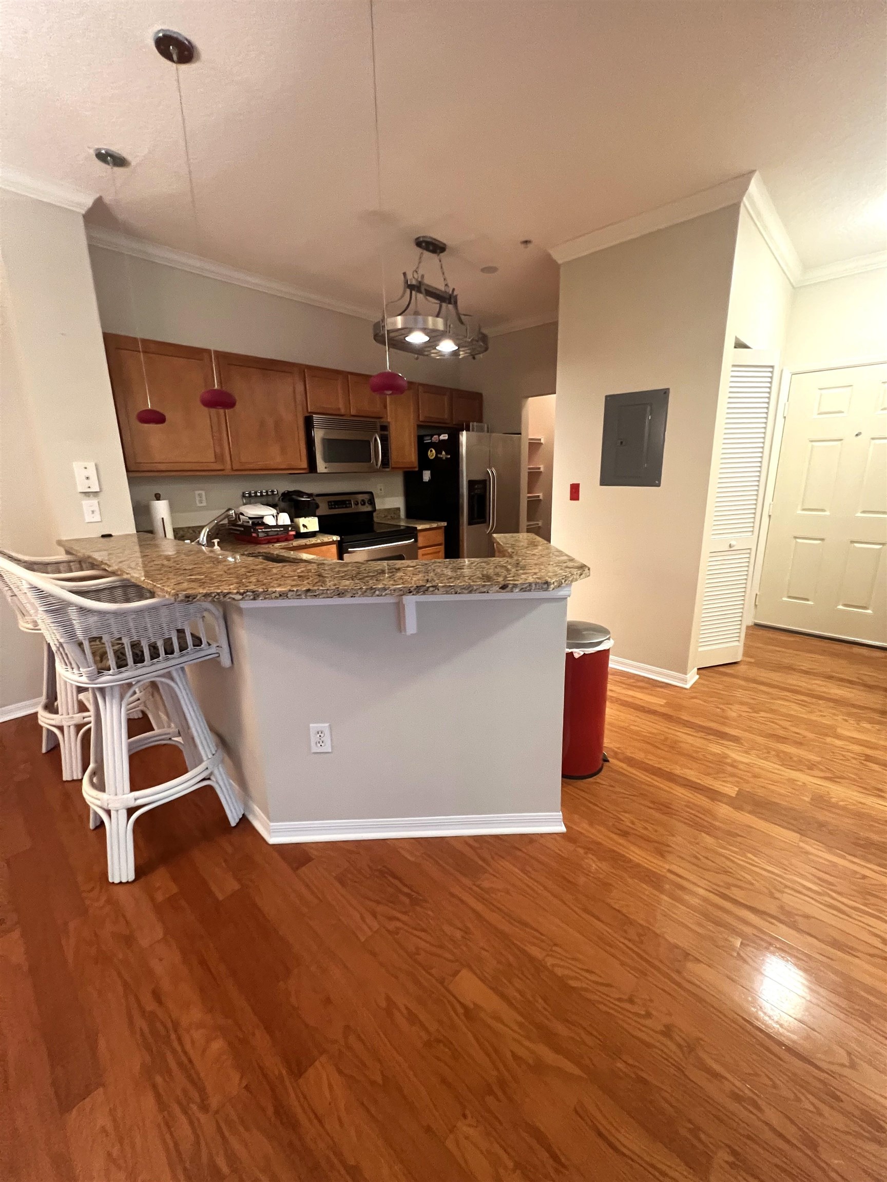 520 Florida Club Boulevard, Unit 212 St. Augustine, FL 32084 - Photo 7 of 28 a view of a kitchen with kitchen island stainless steel appliances wooden floor and living room view