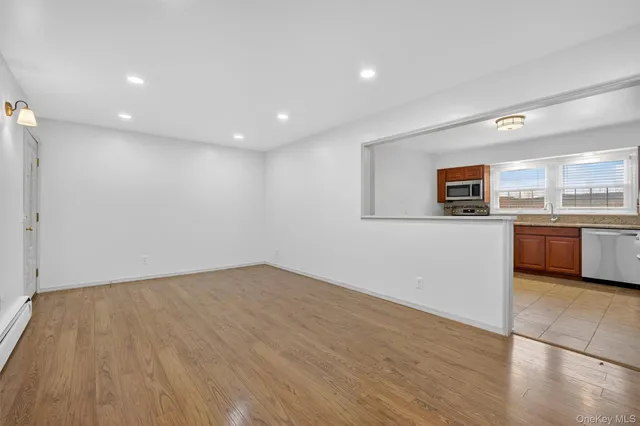 a view of a kitchen with a sink and a refrigerator