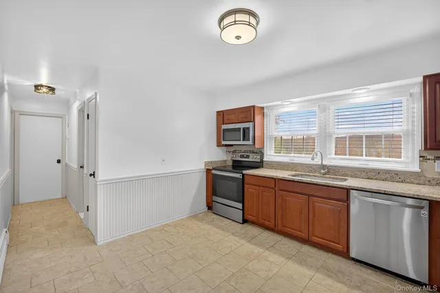 a kitchen with stainless steel appliances granite countertop a stove and a sink