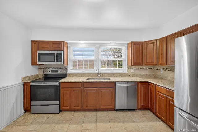 a kitchen with a sink stove and microwave