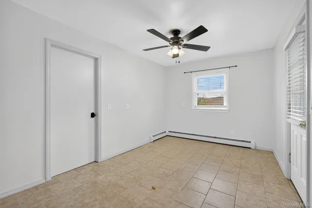 a view of a big room with wooden floor and windows in a room