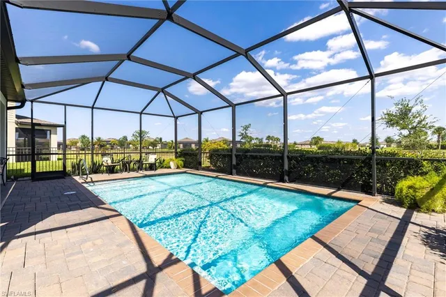 a living room with furniture and floor to ceiling windows