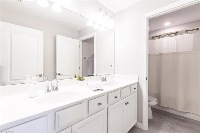 a view of a dining room with furniture a chandelier and wooden floor
