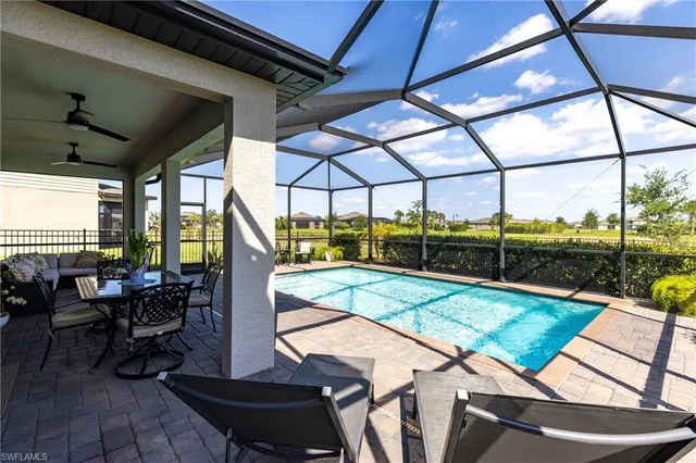 a view of swimming pool with seating area and furniture