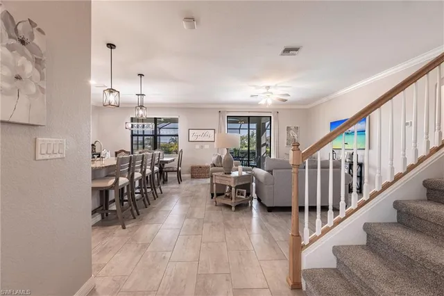 a living room with furniture and a chandelier