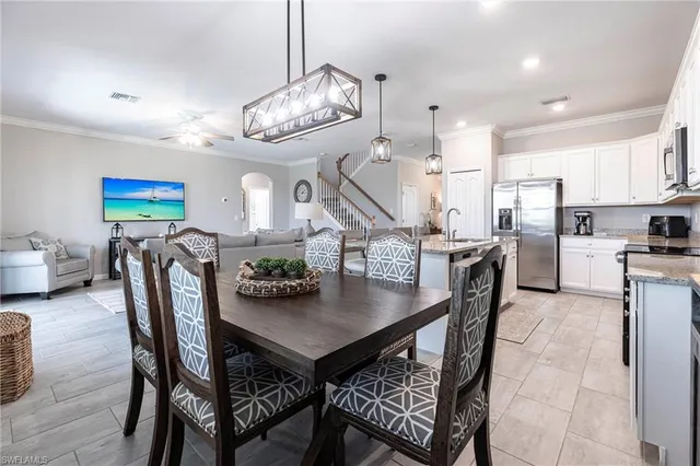 a kitchen with stainless steel appliances granite countertop a sink a stove and cabinets with wooden floor