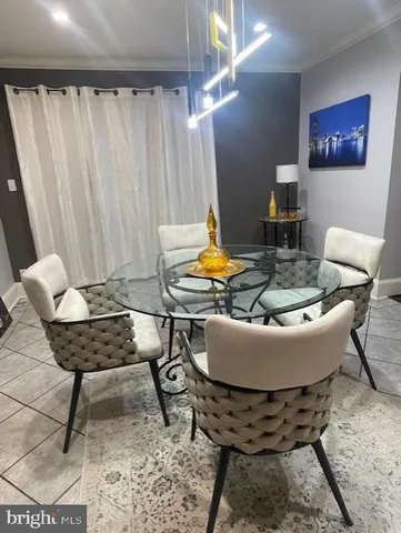 a living room with furniture a flat screen tv and a window