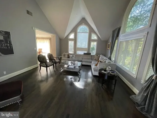 a living room with fireplace furniture and a wooden floor