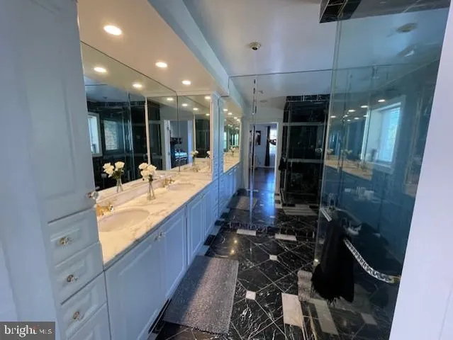 a bathroom with a sink a mirror and a window