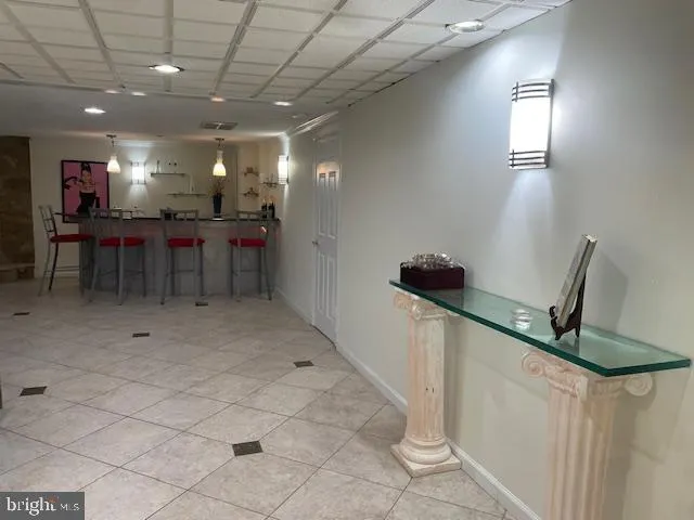 a view of a patio with chairs and potted plants