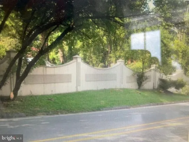 a white house that has a tree in front of it