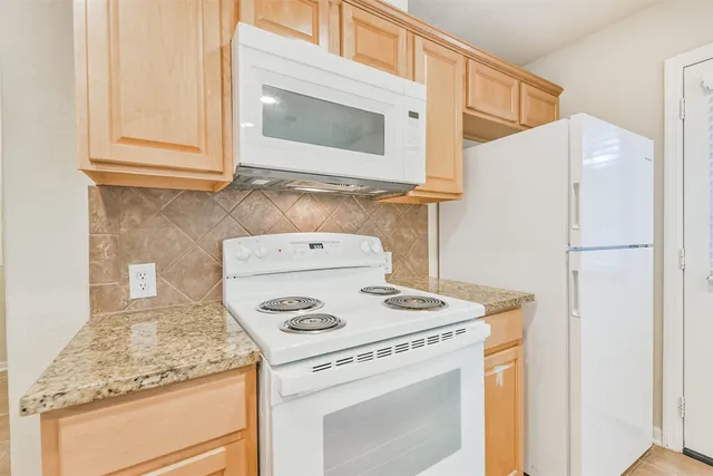 a kitchen with a stove and a microwave