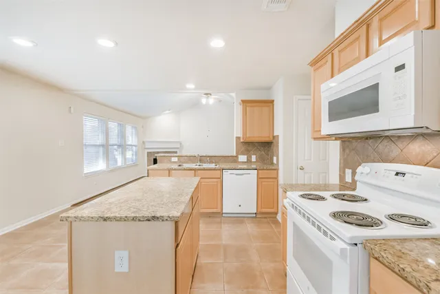 a kitchen with a stove a sink and a microwave