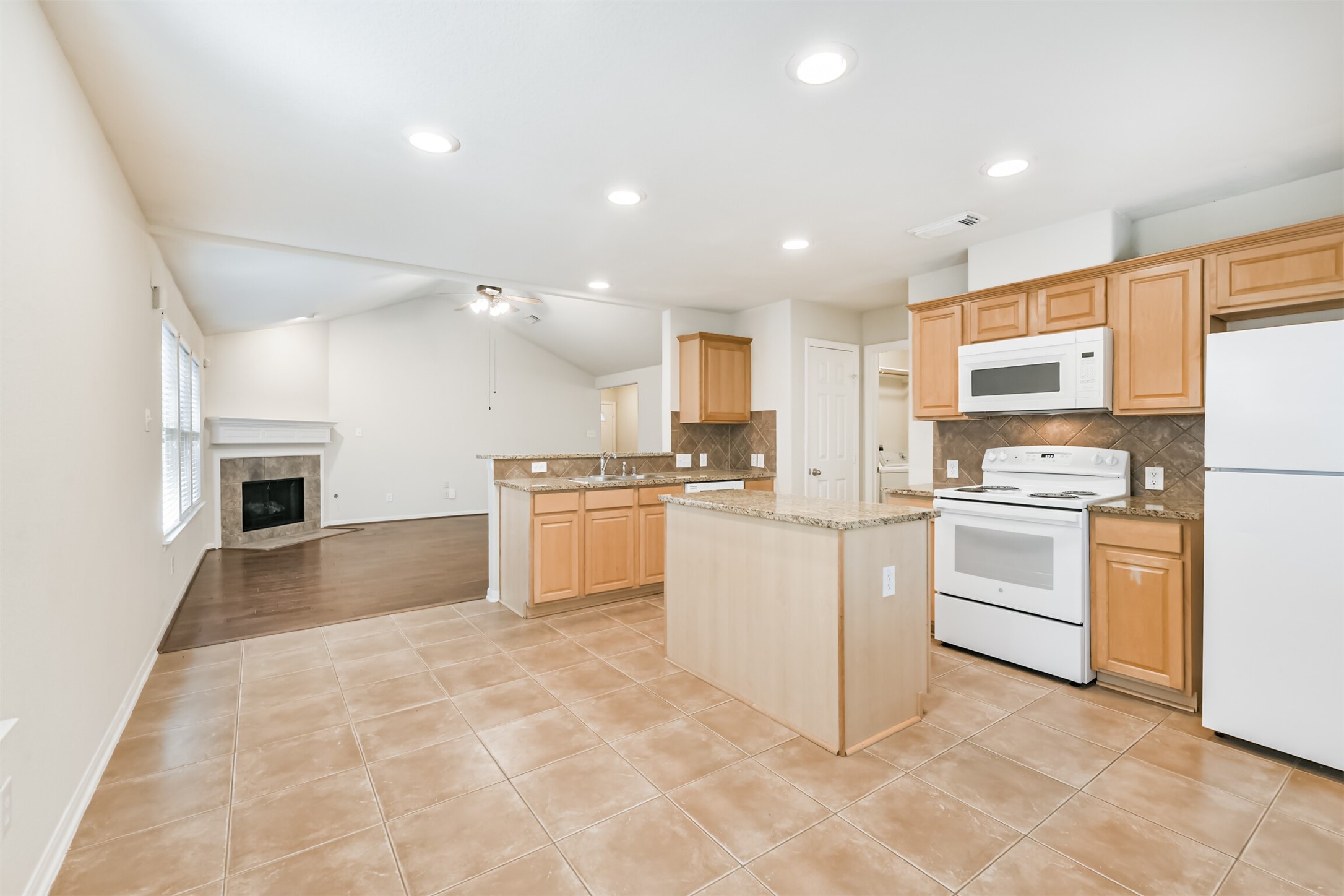 42 Prairie Oak Drive Conroe, TX 77385 - Photo 16 of 33 a kitchen with white cabinets and white appliances