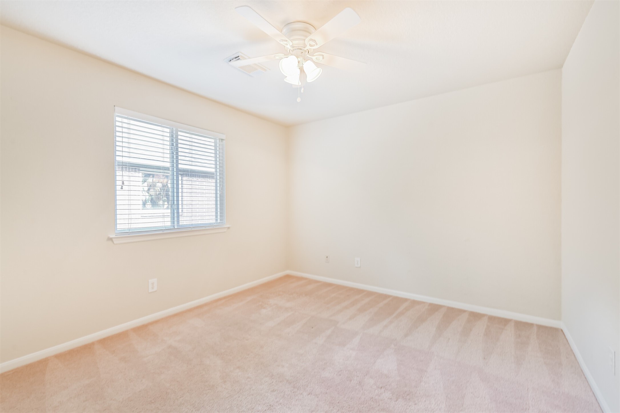 42 Prairie Oak Drive Conroe, TX 77385 - Photo 26 of 33 an empty room with a window and a fan