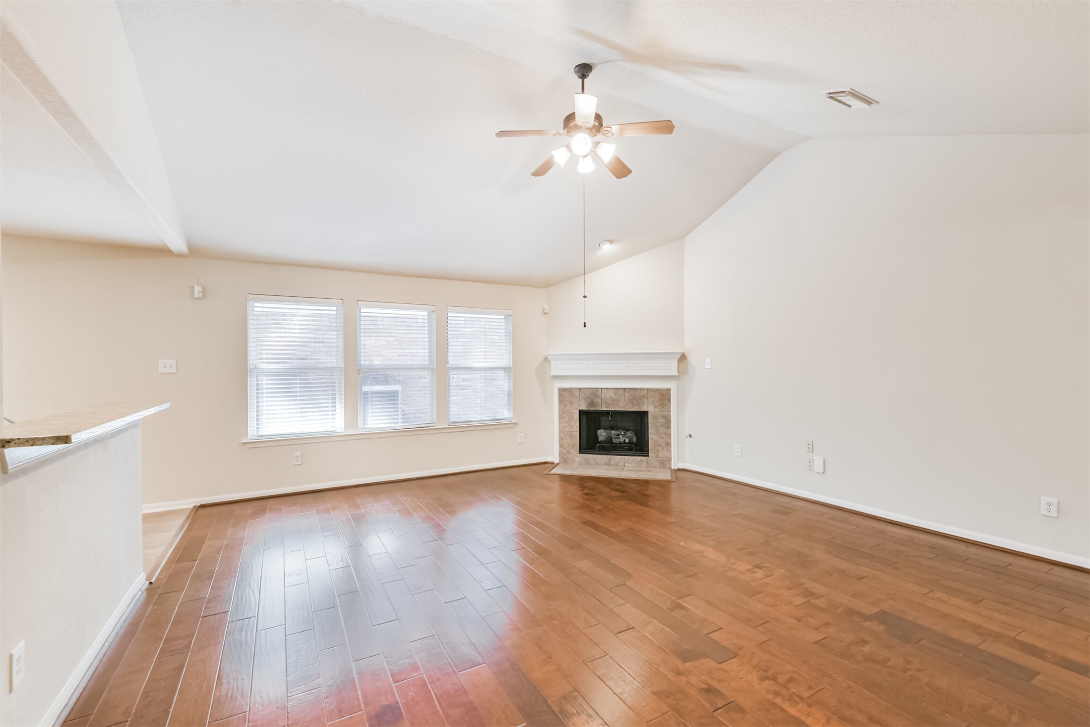 42 Prairie Oak Drive Conroe, TX 77385 - Photo 6 of 33 a view of an empty room with wooden floor and a window