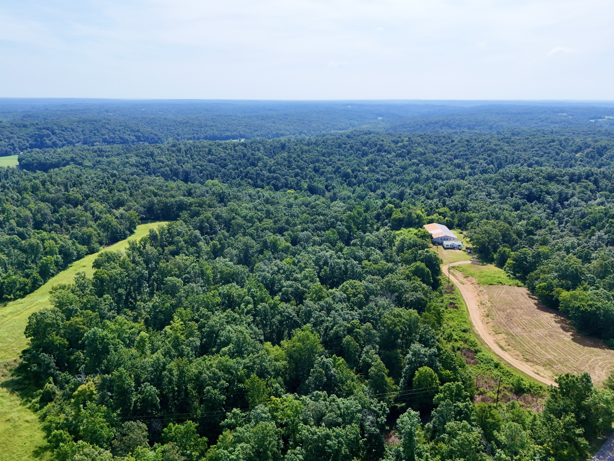 an aerial view of a house with a yard and lake view